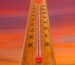 A thermometer spikes against a red sky.
