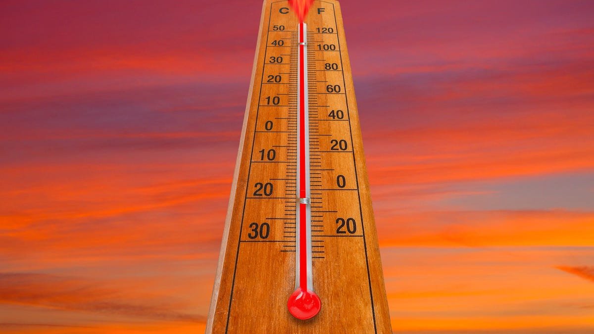 A thermometer spikes against a red sky.