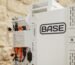 A Base Power battery sits next to a home.