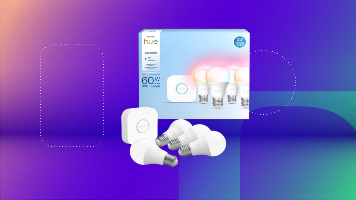 Smart light kit with hub, four light bulbs and box against pink and purple CNET background.