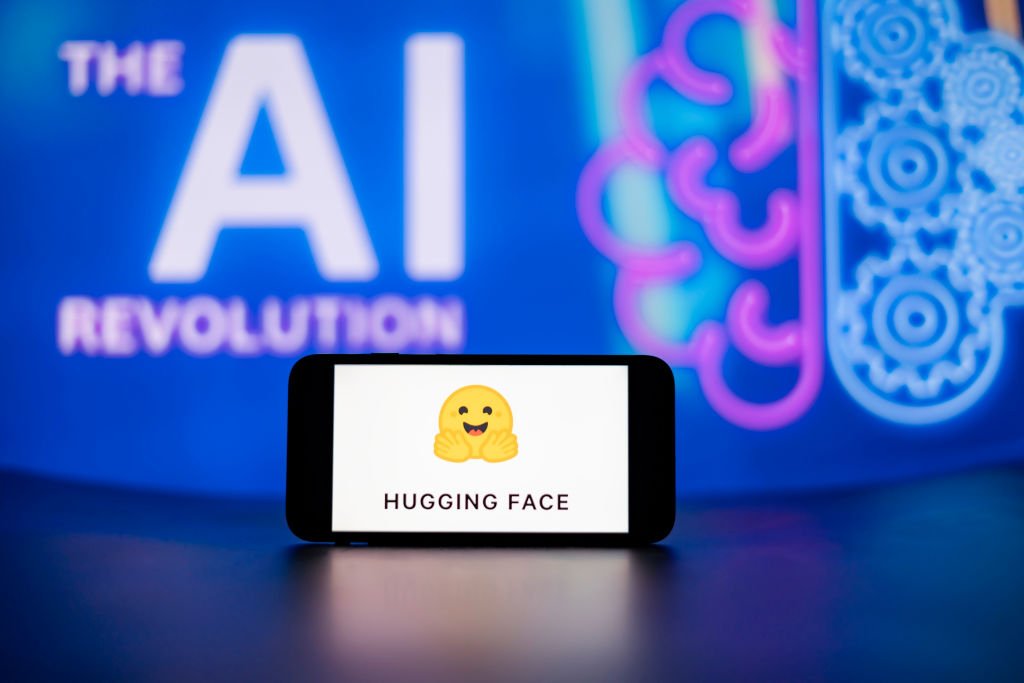 In this photo illustration, the Hugging Face logo seen displayed on a mobile phone screen with the AI (artificial intelligence) revolution symbol in the background.