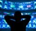 young man standing in front of the projection reflected stock market