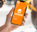 Grubhub app/logo displayed on a smartphone phone held in hand